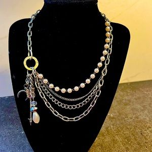 Beautiful multi layered silver and pearl chained necklace with charm detailing